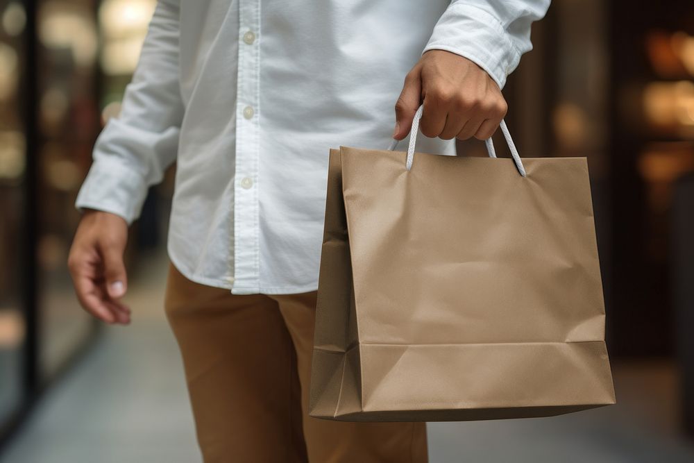 Man holding paper shopping bag