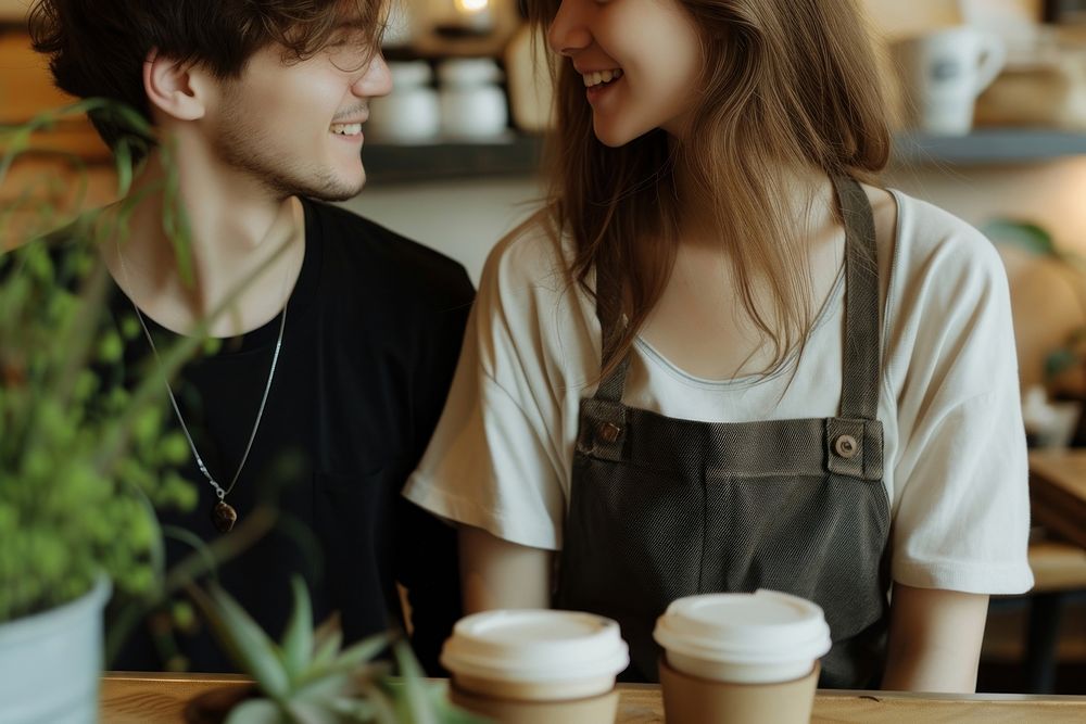 Happy Male And Female Staff In Coffee Shop coffee cup mug.