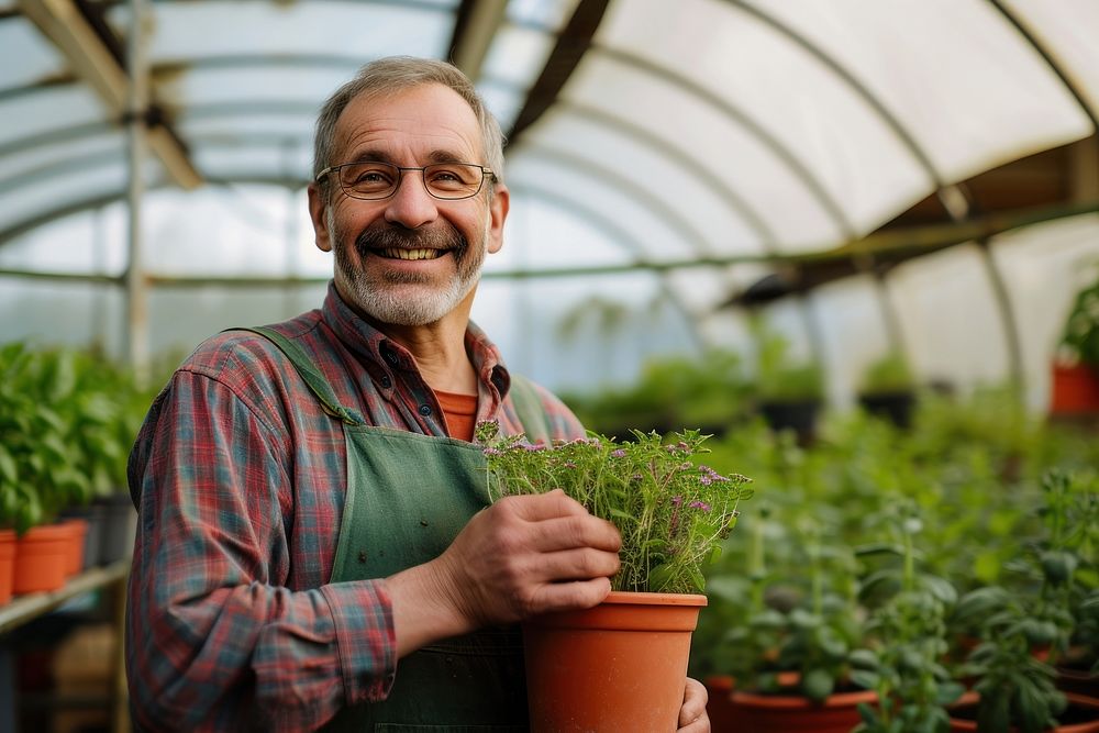 Man nursery owner with pot of flowers greenhouse gardening nature.