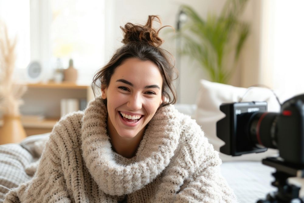 Woman record live video to present product sweater smile photo.