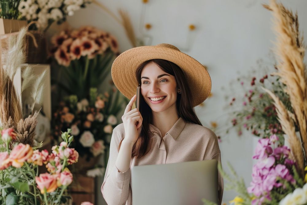 Woman using telephone laptop in Florist Small Business computer flower smile.