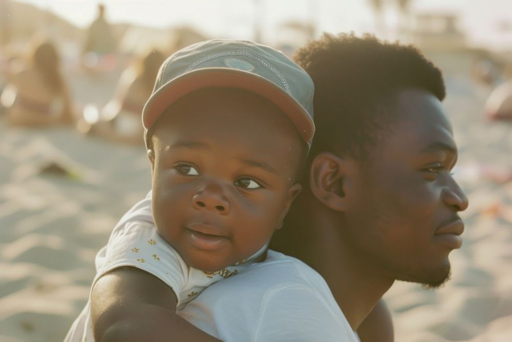 Black dadpiggyback baby on a beach photography portrait family.