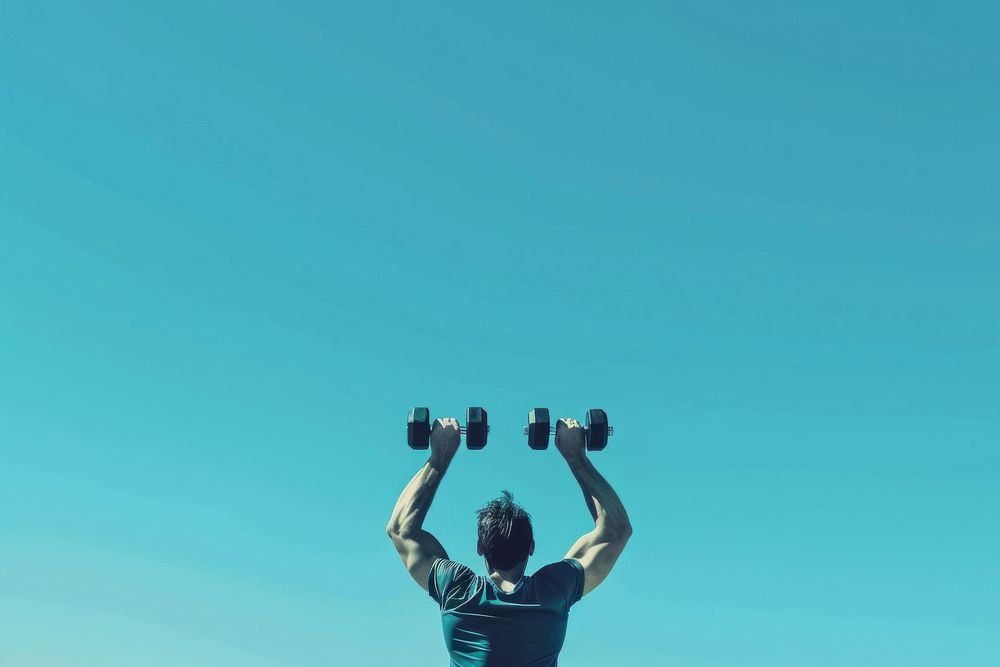 Man lifting two dumbbell exercise fitness sports.