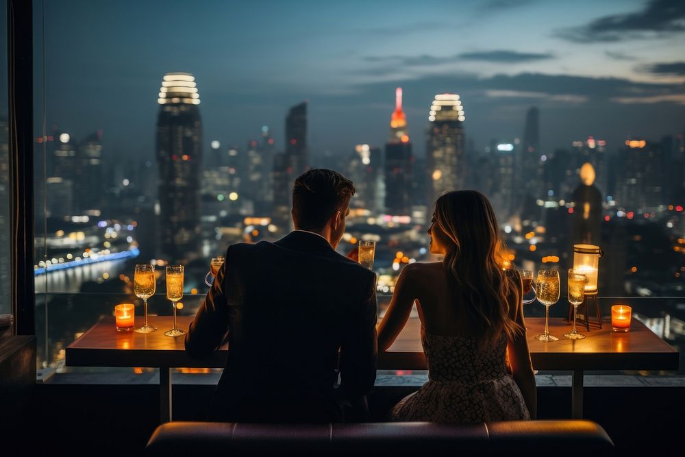 Couple enjoying on a rooftop bar architecture cityscape building.
