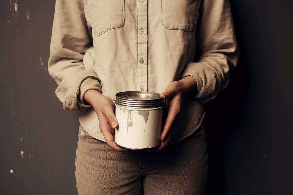 Photography of Person holding paint can person adult cup.