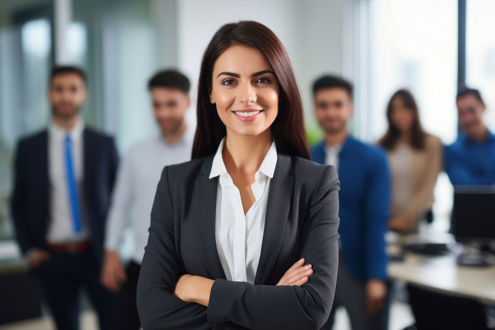 A business woman standing next to a screen in a meeting at the office smiling adult togetherness.