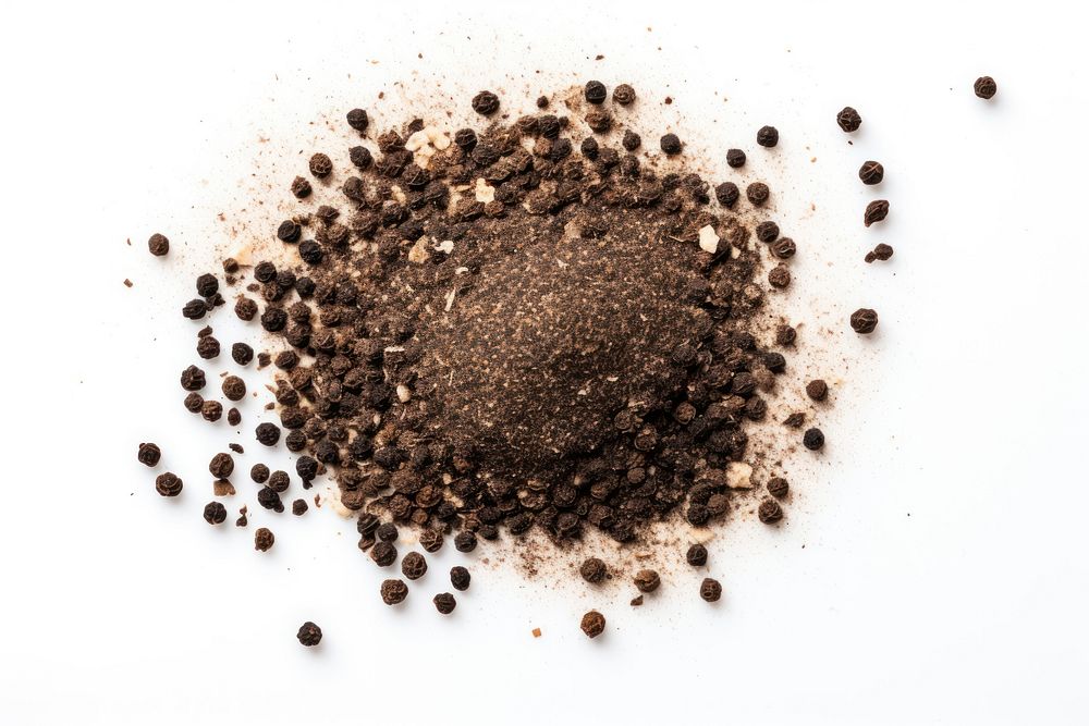 Ground black pepper flakes soil white background ingredient.