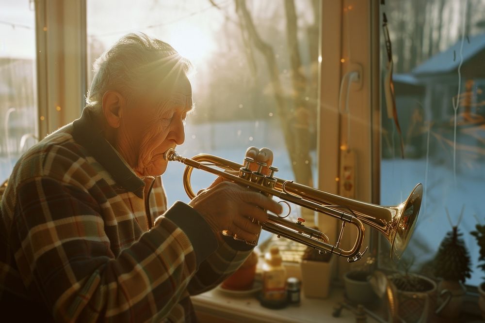 Senior man polishing trumpet adult concentration performance.