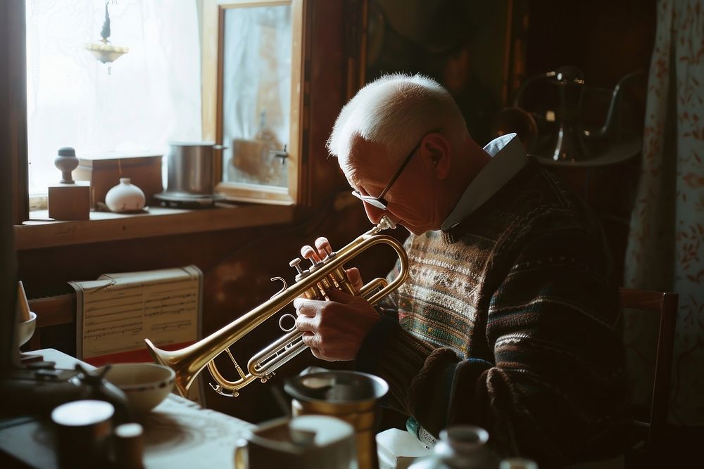 Senior man polishing trumpet adult concentration performance.