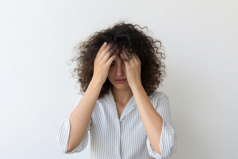 Woman doing facepalm anxiety worried pain.