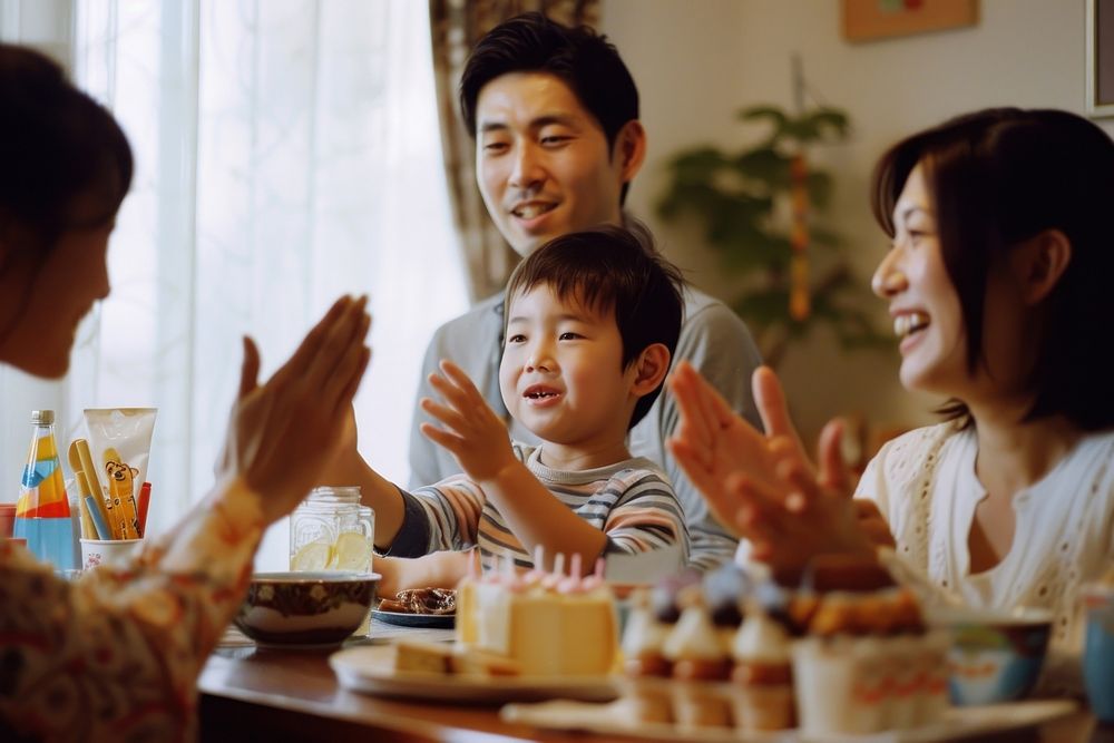 Cheerful family applauding for birthday boy cheerful sitting adult.