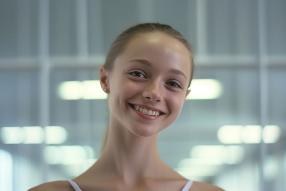 Ballerina smilling in the dance studion smile exercising hairstyle.