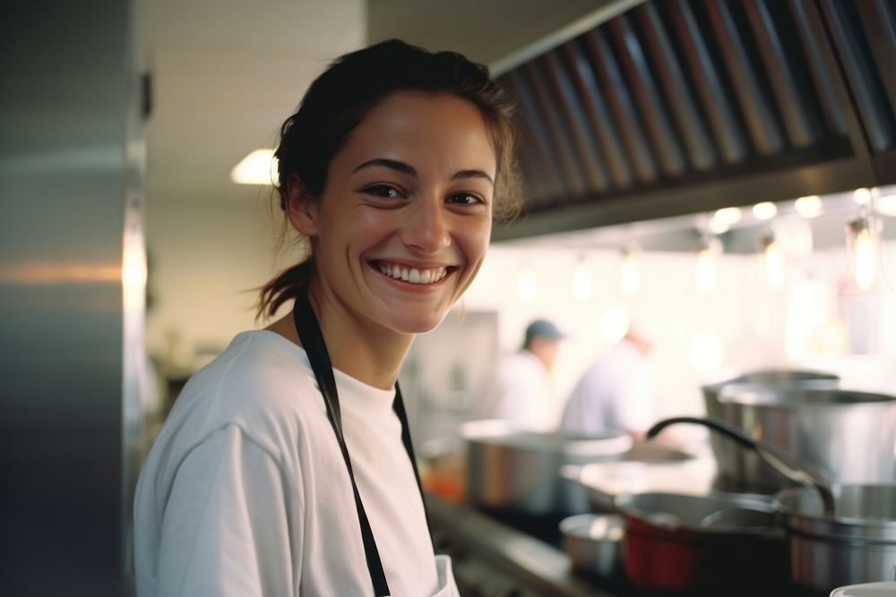 Female chef smilling in the kitchen adult smile restaurant.