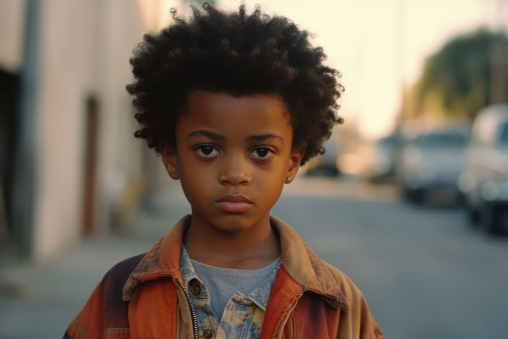 Cute African-American little boy photography portrait street.