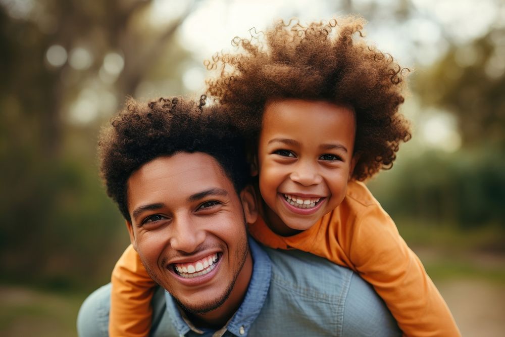 African American mother and son smile laughing adult.