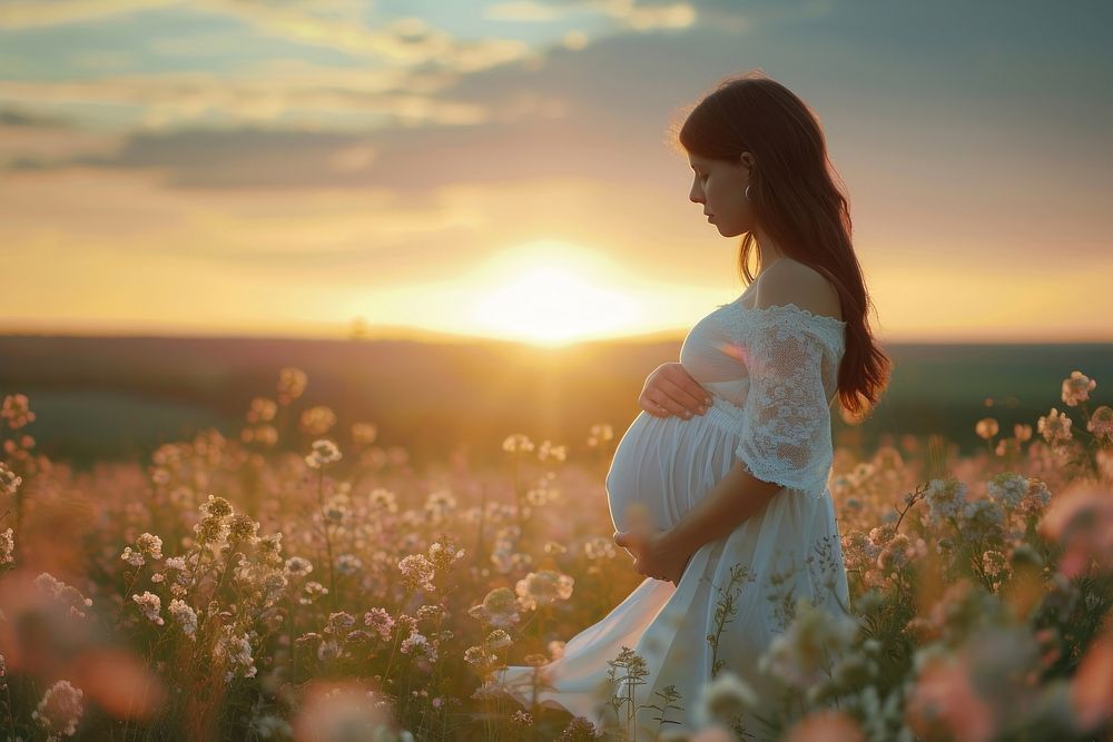 Woman pregnant sunlight portrait outdoors.