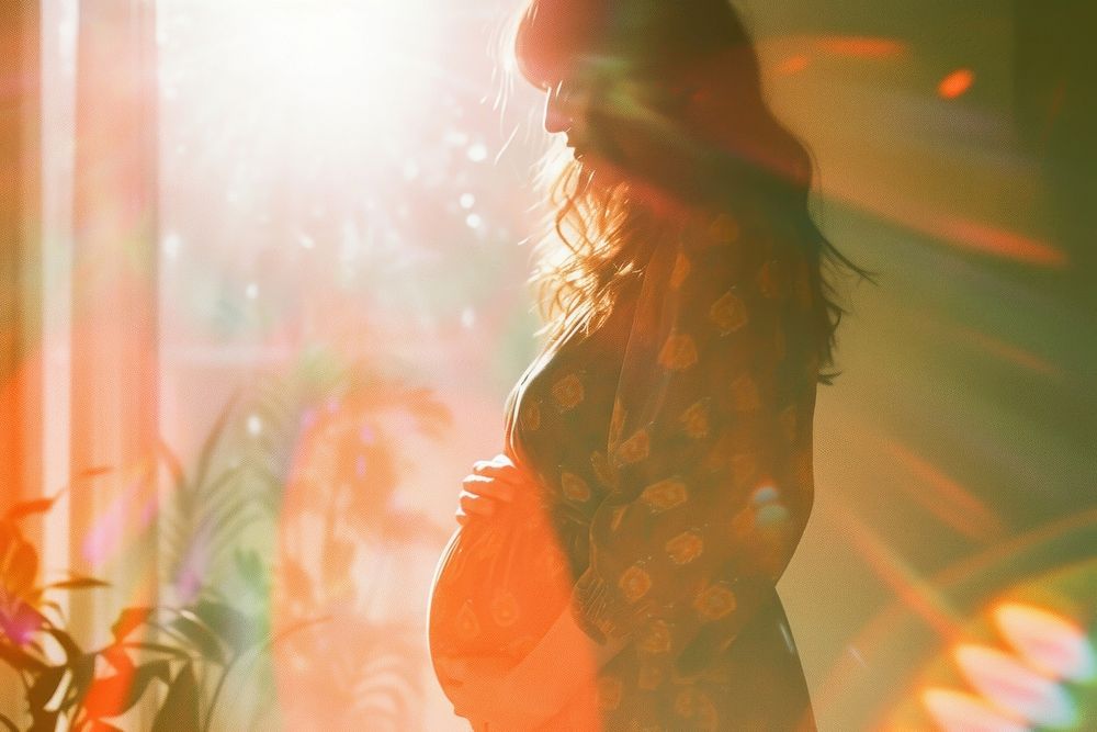 Woman pregnant light leaks photography portrait sunlight.
