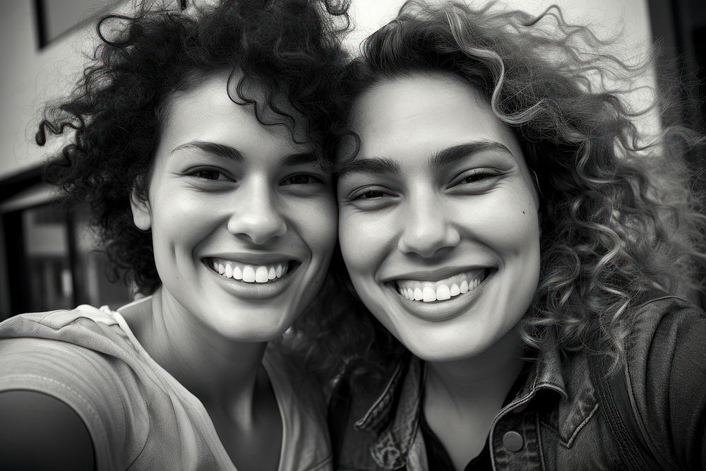 Women friends laughing portrait selfie.