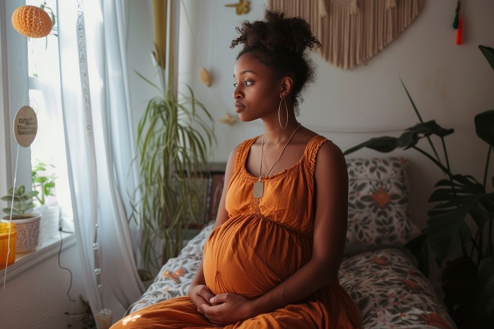 Black woman pregnant sitting adult contemplation.