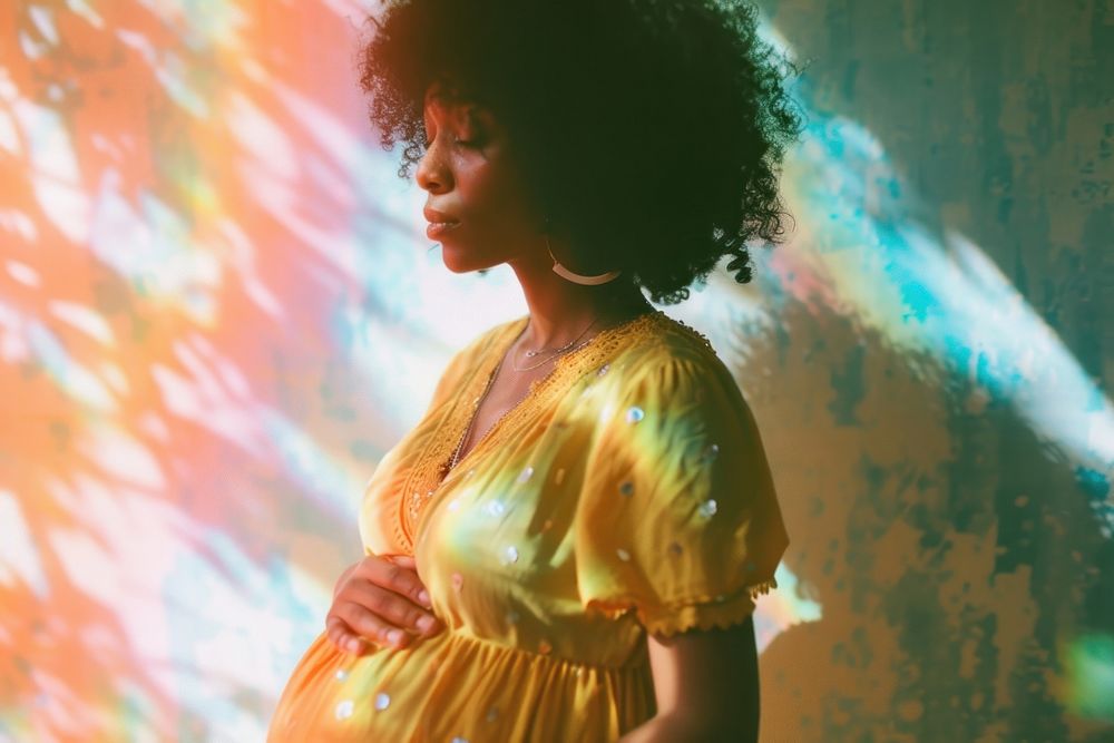 Black woman pregnant light leaks adult performance hairstyle.
