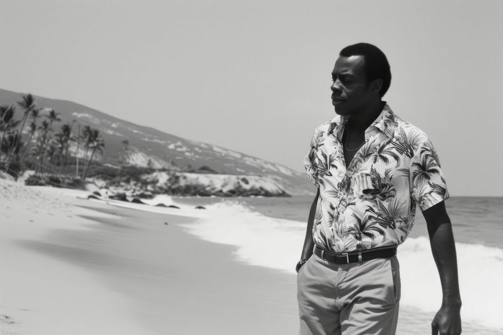 Black man beach portrait outdoors.