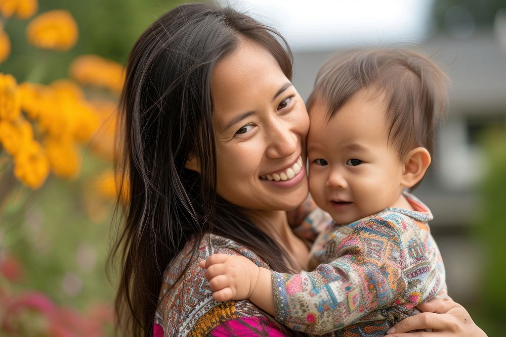 Southeast asian mother holding a toddler photography portrait hugging.