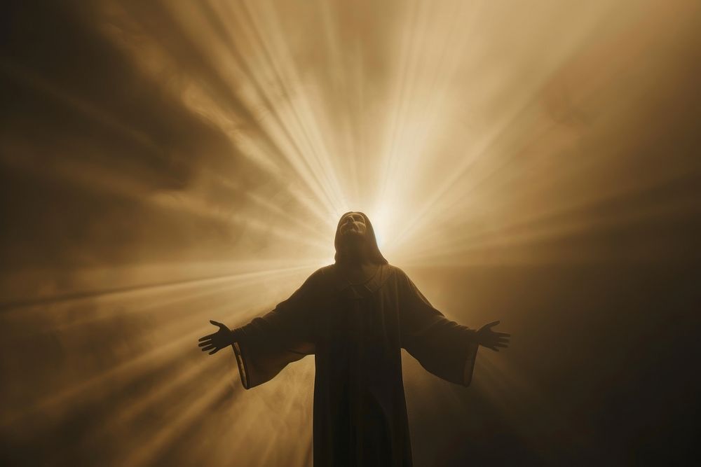Silhouette of Jesus Christ in rays of light sunlight sky spirituality.