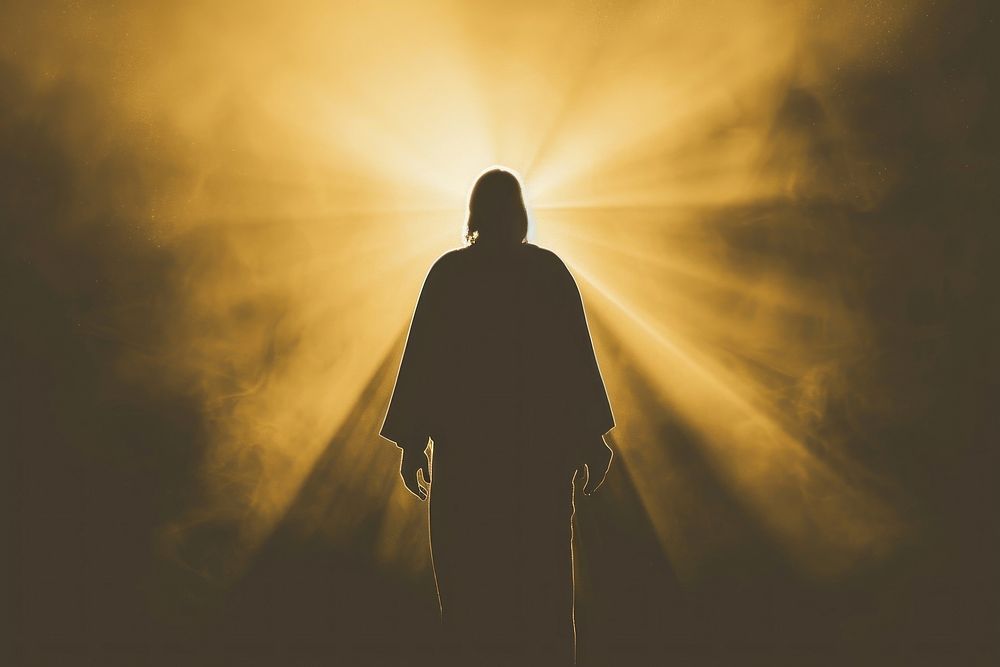 Silhouette of Jesus Christ in rays of light backlighting sunlight adult.