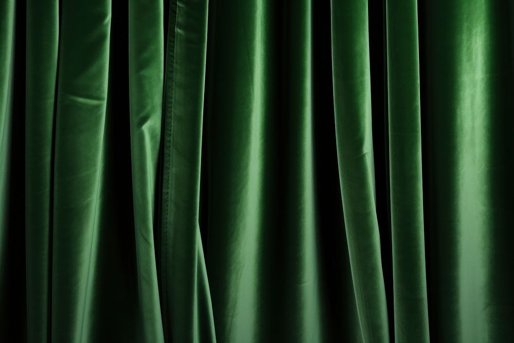 Green velvet curtain backgrounds monochrome darkness.
