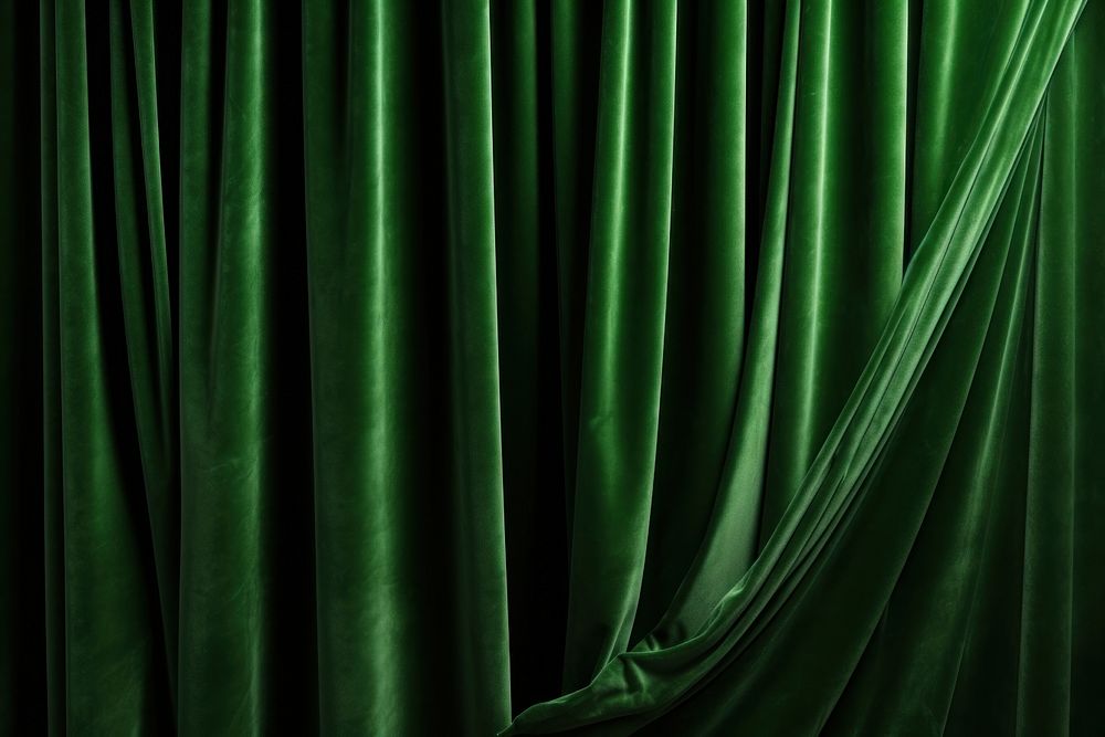 A green velvet curtain backgrounds darkness elegance.