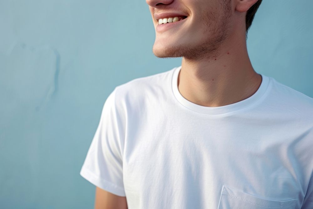 A happy man wearing white t shirt t-shirt adult blue.