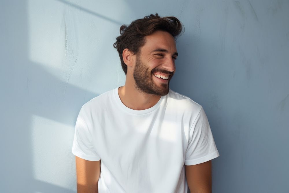 A happy man wearing white t shirt laughing adult smile.
