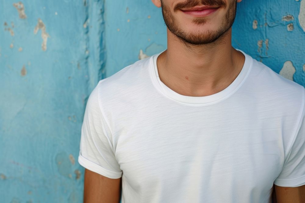 A happy man wearing white t shirt t-shirt sleeve blue.