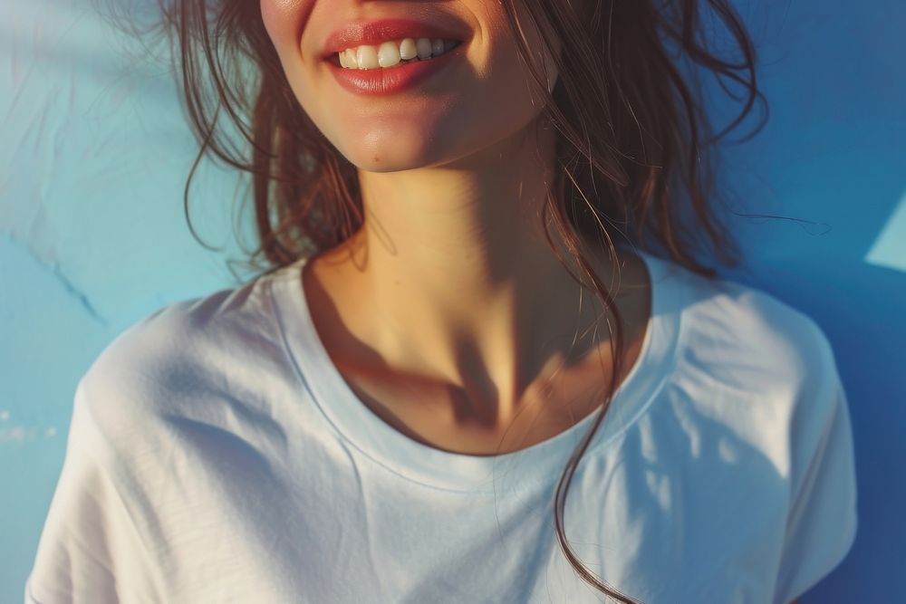 A happy woman wearing white t shirt blue happiness enjoyment.