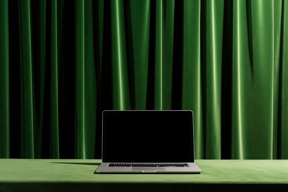 A laptop green computer curtain.