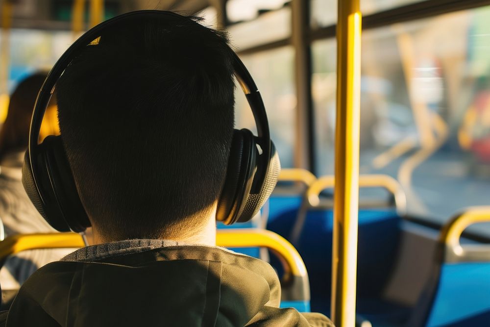 Young man listening music headphones headset vehicle.