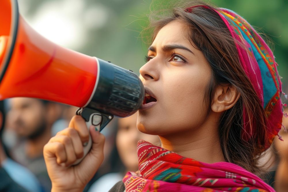 Young indian woman using megaphone adult day headshot.