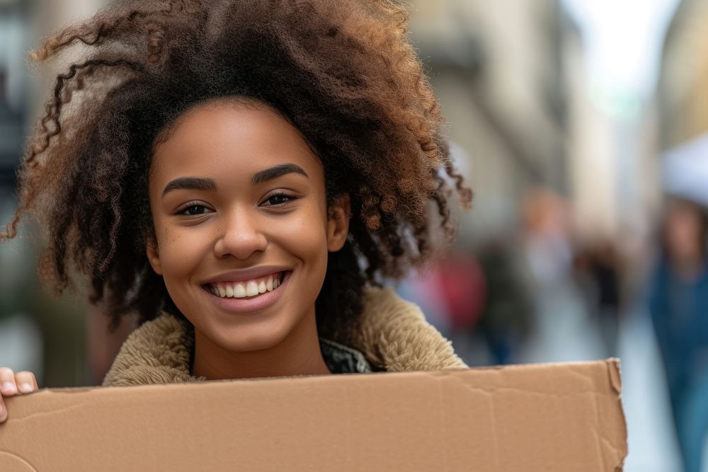 Young african american woman cardboard smile happy.