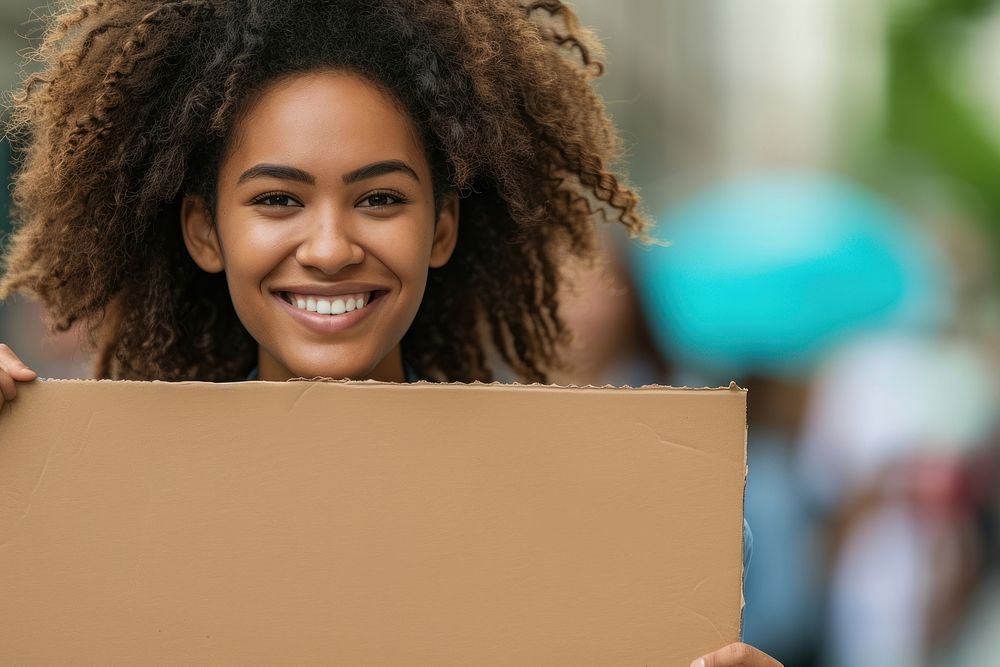 Young african american woman cardboard holding smile.