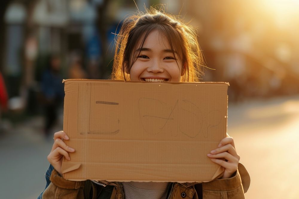 Young asian woman cardboard holding happy.