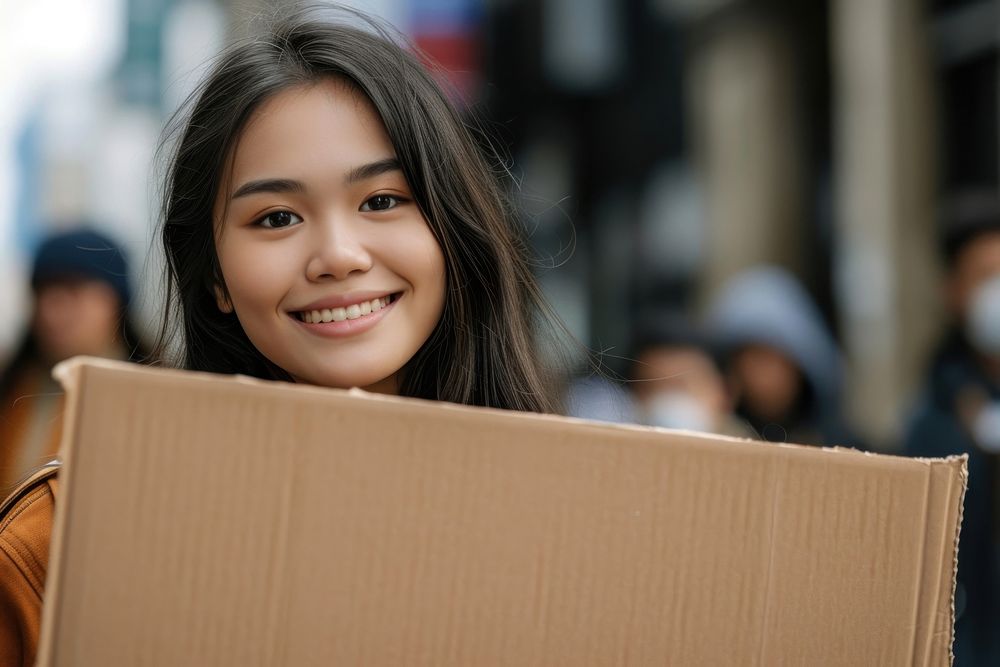 Young asian woman cardboard holding smile.
