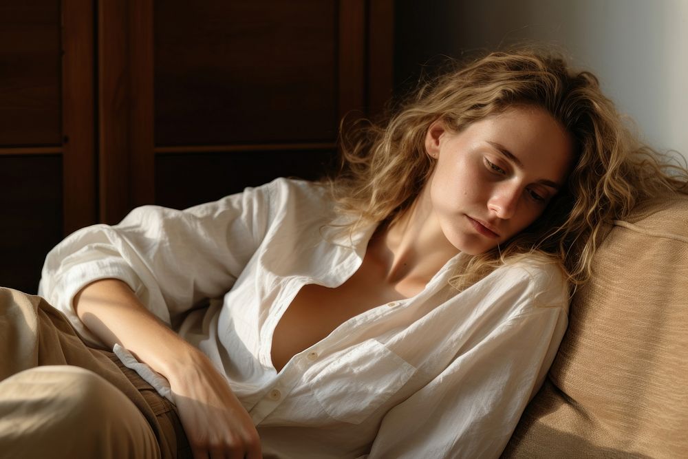 Woman laying on a couch and reading a book photography portrait adult.