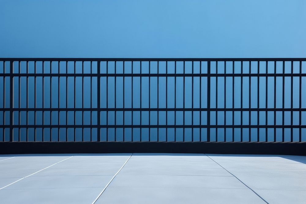 A black grid fence gate wall blue.