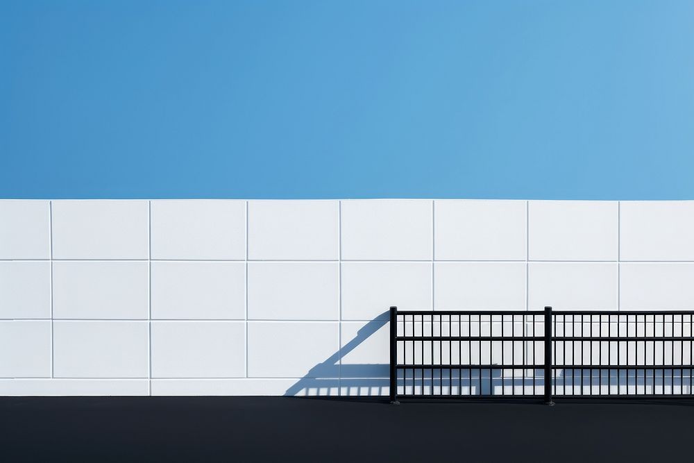 A black grid fence wall architecture building.