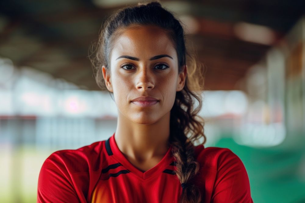 Latinx women soccer player red contemplation determination.