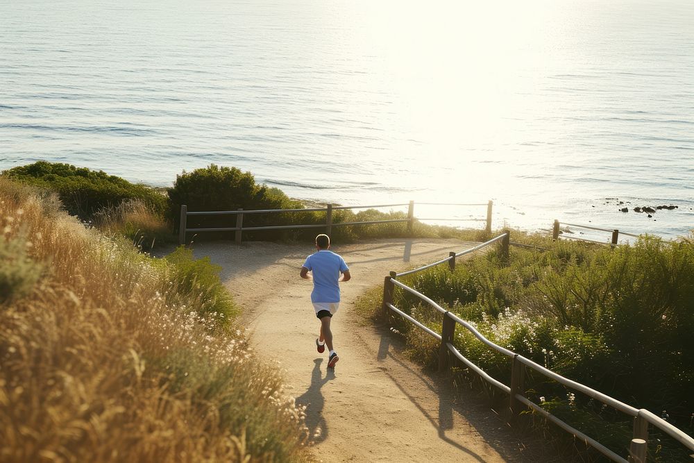 Healthy man running coast sea outdoors.