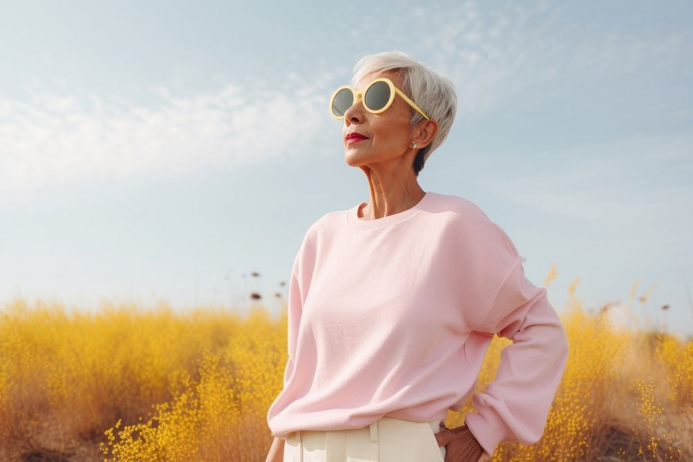 A senior woman wear white sunglasses portrait outdoors.