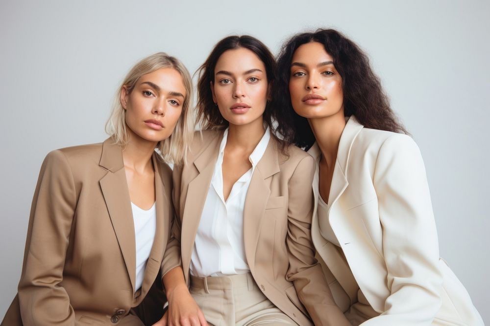 Three diverse women adult suit togetherness.