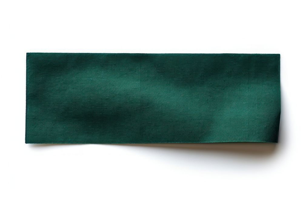 Piece of dark green cloth textile adhesive strip paper white background simplicity.