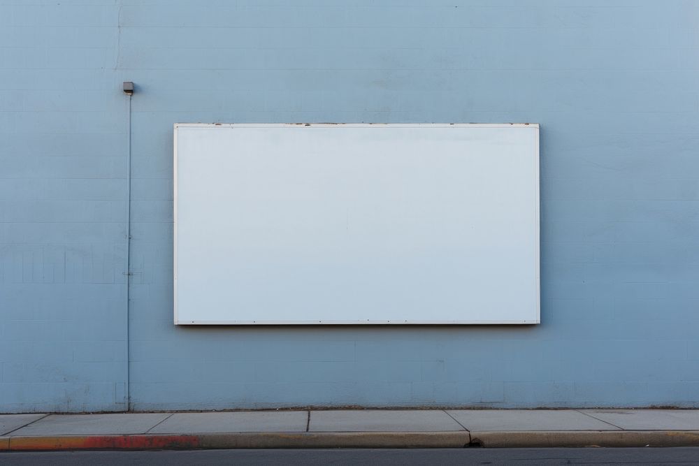 A blank sign white wall blue.